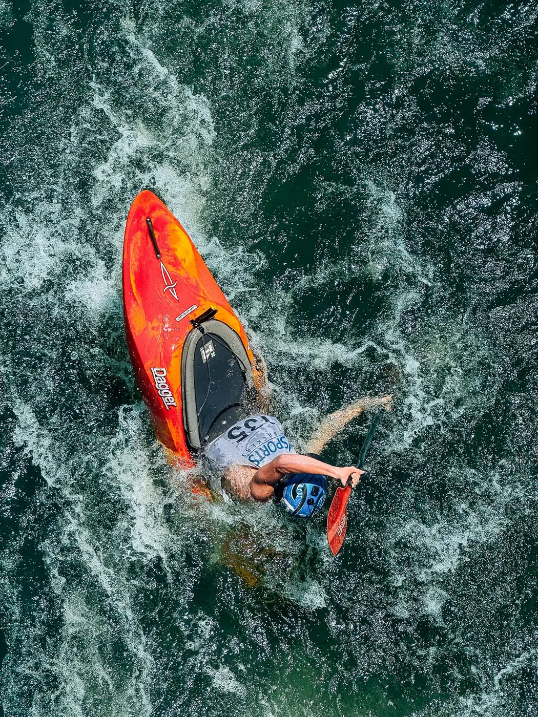 A kayaker cutting through open water
