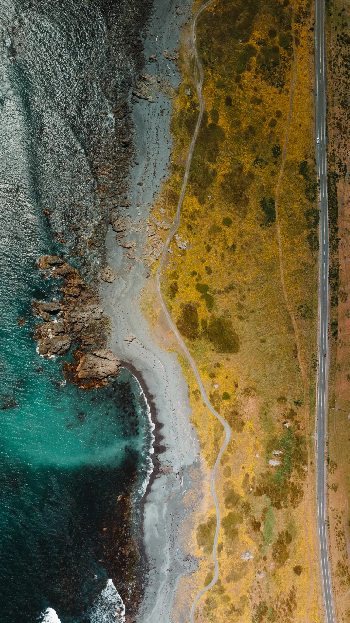 Aerial view of a turquoise mountain shoreline