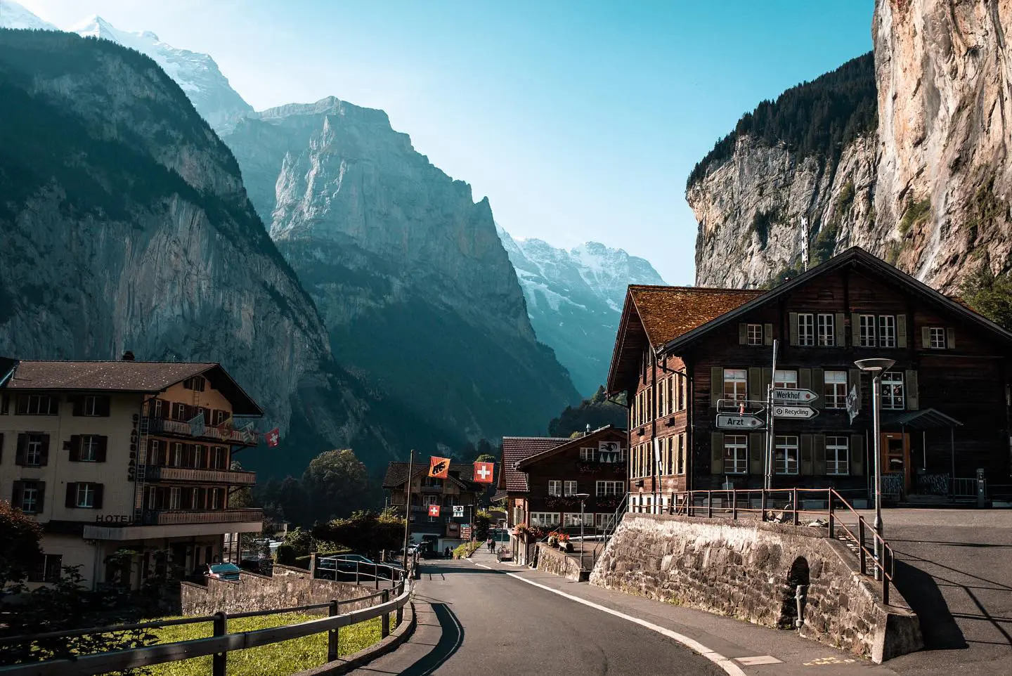 Village beneath steep alpine cliffs