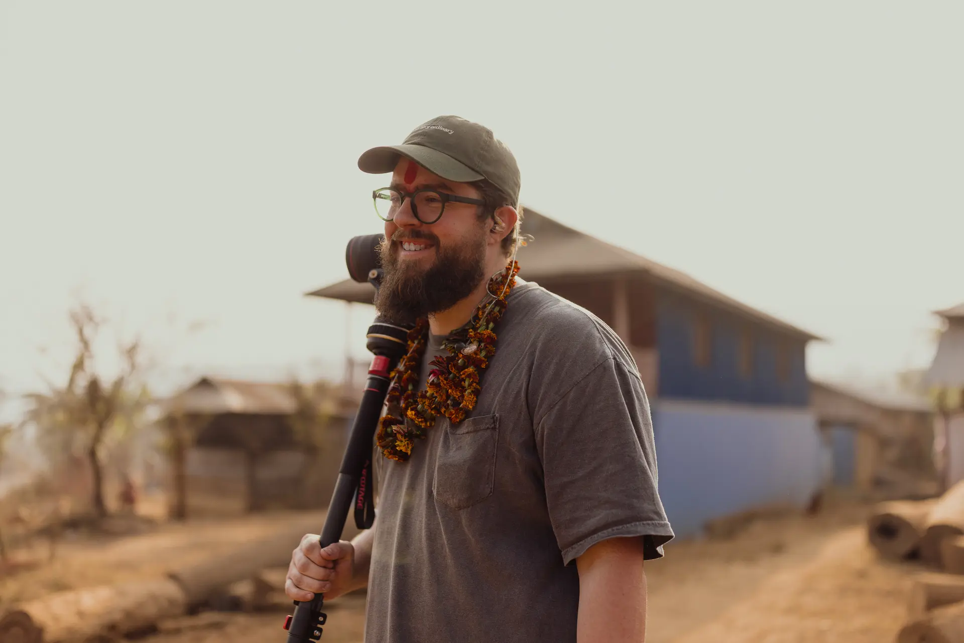 Portrait of a traveler wearing beads in the field