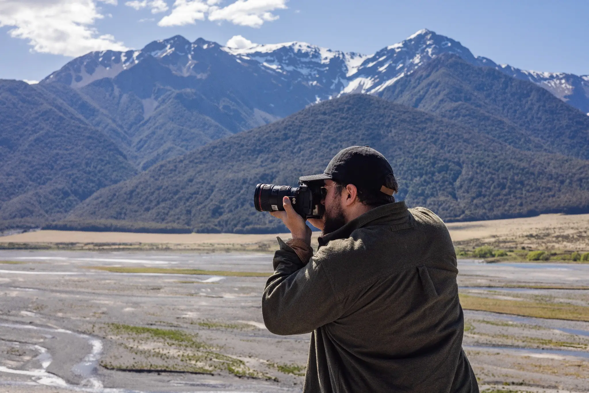 Photographer framing a mountain landscape