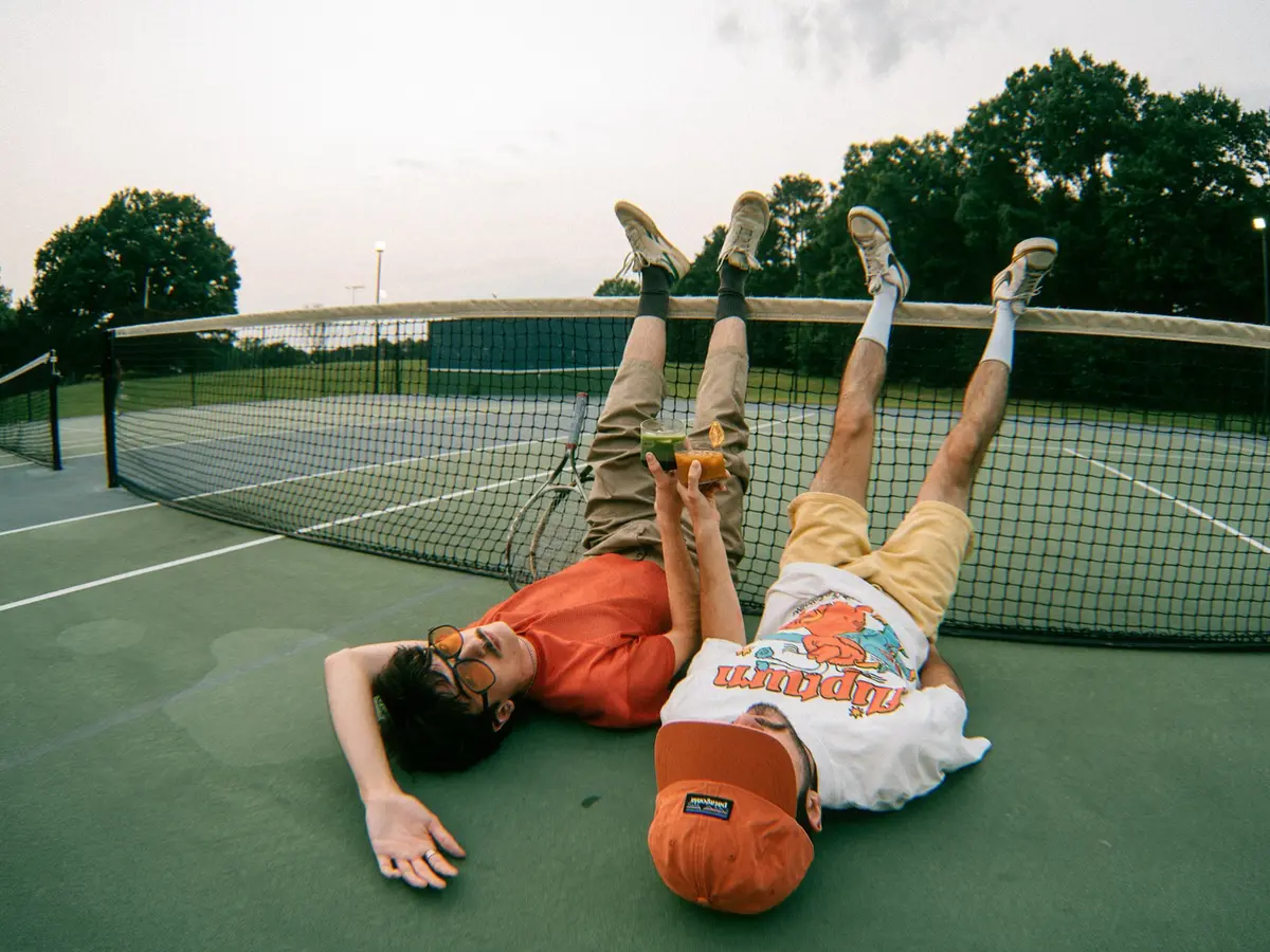 Friends relaxing on a tennis court