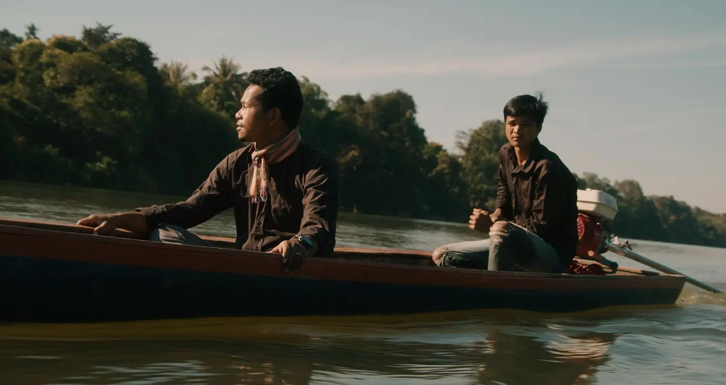 People traveling by canoe at dusk